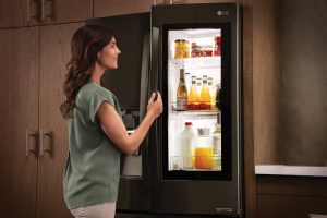 A woman opening a fridge | Chattanooga Home Inspector | kitchen Chattanooga