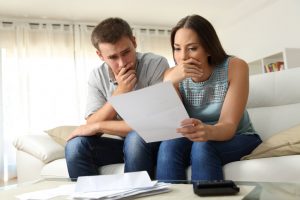 a couple thinking and holding a paper | Chattanooga Home Inspector | Insurance Chattanooga