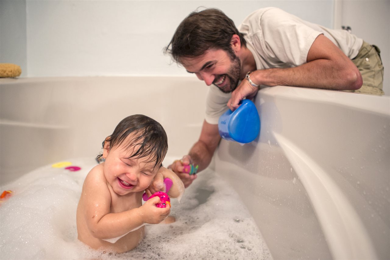 a baby in an bathtub tickled by Daddy |Chattanooga Home Inspector | value-enhancing home improvement projects Chattanooga